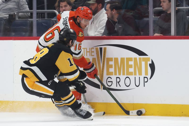 Dec 9, 2025; Pittsburgh, Pennsylvania, USA;  Anaheim Ducks center Ryan Strome (16) moves the puck against Pittsburgh Penguins center Tommy Novak (18) during the second period at PPG Paints Arena. Mandatory Credit: Charles LeClaire-Imagn Images