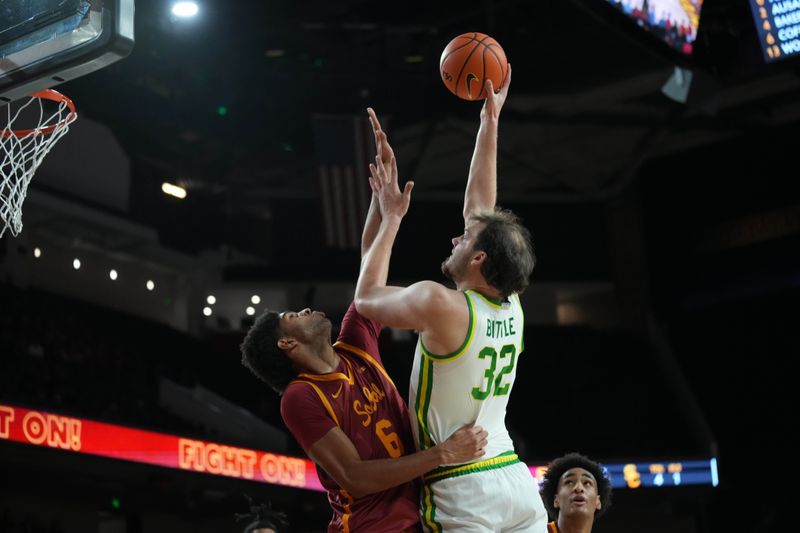 Feb 21, 2026; Los Angeles, California, USA; Oregon Ducks center Nate Bittle (32) shoots the ball against Southern California Trojans forward Jacob Cofie (6) in the first half at Galen Center. Mandatory Credit: Kirby Lee-Imagn Images