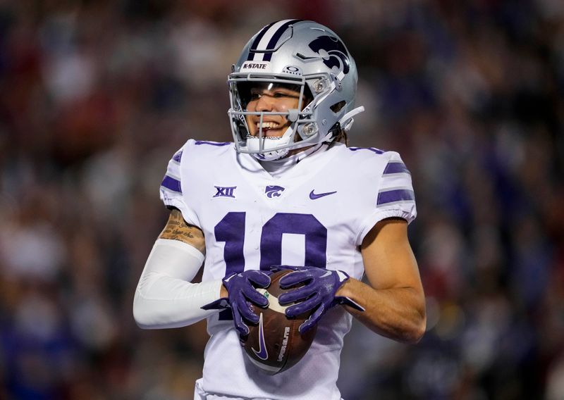 Nov 18, 2023; Lawrence, Kansas, USA; Kansas State Wildcats wide receiver Keagan Johnson (10) scores a touchdown during the first half against the Kansas State Wildcats at David Booth Kansas Memorial Stadium. Mandatory Credit: Jay Biggerstaff-USA TODAY Sports