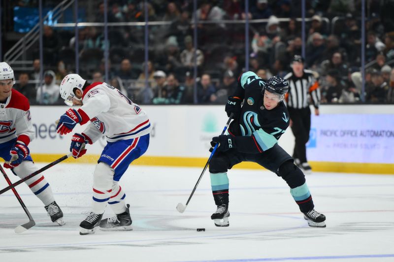 Oct 28, 2025; Seattle, Washington, USA; Seattle Kraken center Berkly Catton (77) plays the puck while defended by Montreal Canadiens center Alex Newhook (15) during the third period at Climate Pledge Arena. Mandatory Credit: Steven Bisig-Imagn Images