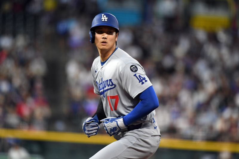Jun 25, 2025; Denver, Colorado, USA; Los Angeles Dodgers two-way player Shohei Ohtani (17) at first base after singling during the sixth inning against the Colorado Rockies at Coors Field. Mandatory Credit: Christopher Hanewinckel-Imagn Images