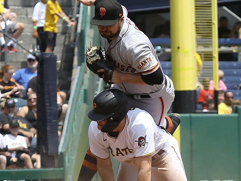 Jul 16, 2023; Pittsburgh, Pennsylvania, USA;  Pittsburgh Pirates right fielder Henry Davis (32) upends San Francisco Giants third baseman J.D. Davis (top) on a steal at third base during the sixth inning at PNC Park. Mandatory Credit: Charles LeClaire-USA TODAY Sports