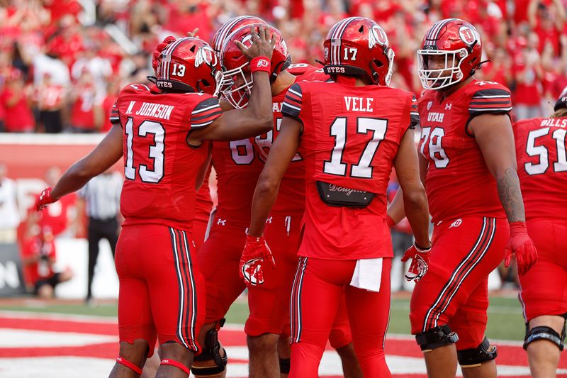 Aug 31, 2023; Salt Lake City, Utah, USA; Utah Utes quarterback Nate Johnson (13) is congratulated after his touchdown in the first half against the Florida Gators at Rice-Eccles Stadium. Mandatory Credit: Jeff Swinger-USA TODAY Sports