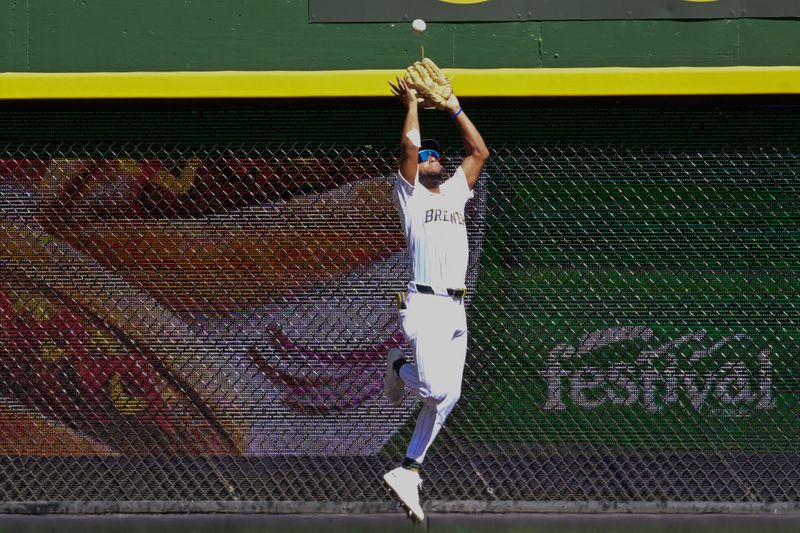 Aug 11, 2024; Milwaukee, Wisconsin, USA; Milwaukee Brewers left fielder Jackson Chourio (11) catches ball hit by Cincinnati Reds left fielder Spencer Steer (not pictured) for a sacrifice fly in the seventh inning at American Family Field. Mandatory Credit: Benny Sieu-USA TODAY Sports