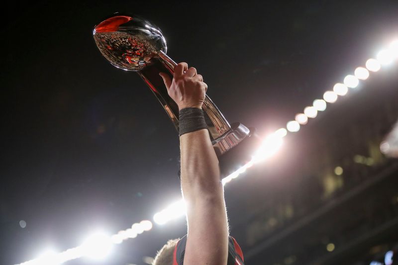 Dec 4, 2021; Cincinnati, Ohio, USA; Cincinnati Bearcats offensive lineman Cody Lamb (65) holds up the American Athletic Conference championship trophy after the game against the Houston Cougars at Nippert Stadium. Mandatory Credit: Katie Stratman-USA TODAY Sports