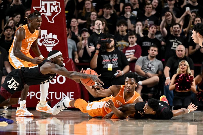 Feb 21, 2023; College Station, Texas, USA;  Texas A&M Aggies guard Wade Taylor IV (4), guard Tyrece Radford (23) and Tennessee Volunteers forward Tobe Awaka (11) dive for a loose during the second half at Reed Arena. Mandatory Credit: Maria Lysaker-USA TODAY Sports