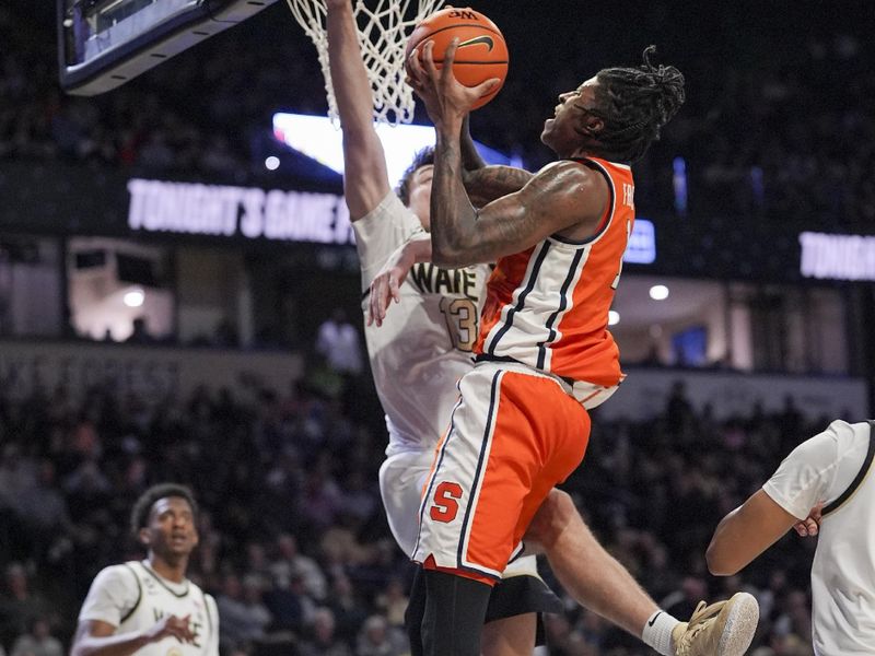 Feb 28, 2026; Winston-Salem, North Carolina, USA;  Syracuse Orange forward William Kyle III (42) drives to the basket defended by Wake Forest Demon Deacons forward Cooper Schwieger (13) during the second half at Lawrence Joel Veterans Memorial Coliseum. Mandatory Credit: Jim Dedmon-Imagn Images