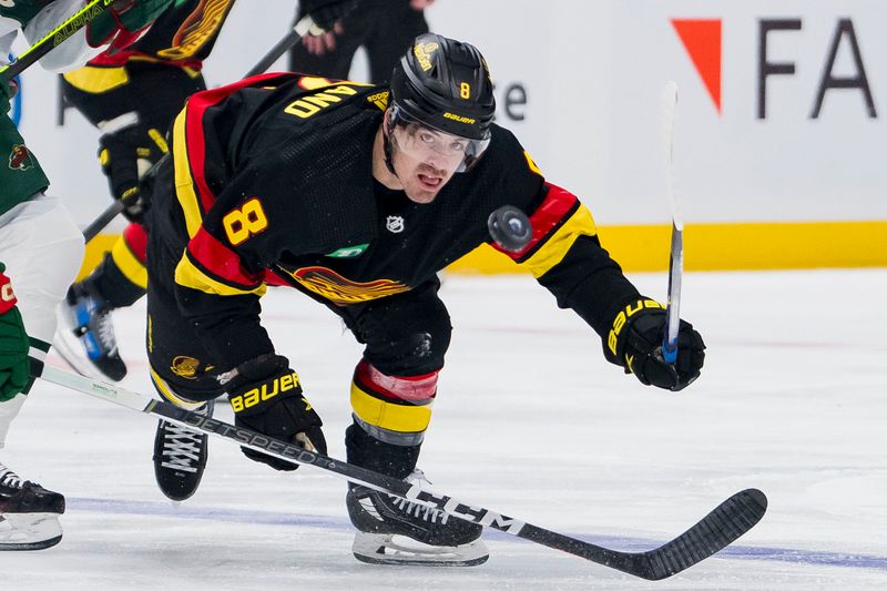 Dec 7, 2023; Vancouver, British Columbia, CAN; Vancouver Canucks forward Conor Garland (8) reaches for the loose puck against the Minnesota Wild in the first period at Rogers Arena. Mandatory Credit: Bob Frid-USA TODAY Sports