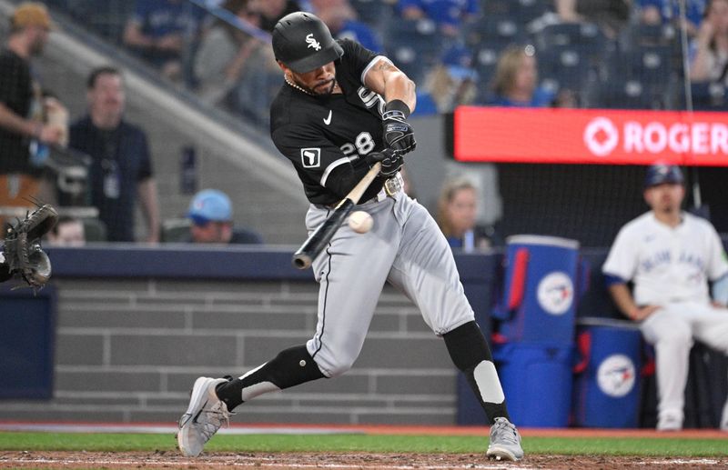 May 21, 2024; Toronto, Ontario, CAN;  Chicago White Sox center fielder Tommy Pham (28) hits a single against the Toronto Blue Jays in the seventh inning at Rogers Centre. Mandatory Credit: Dan Hamilton-USA TODAY Sports