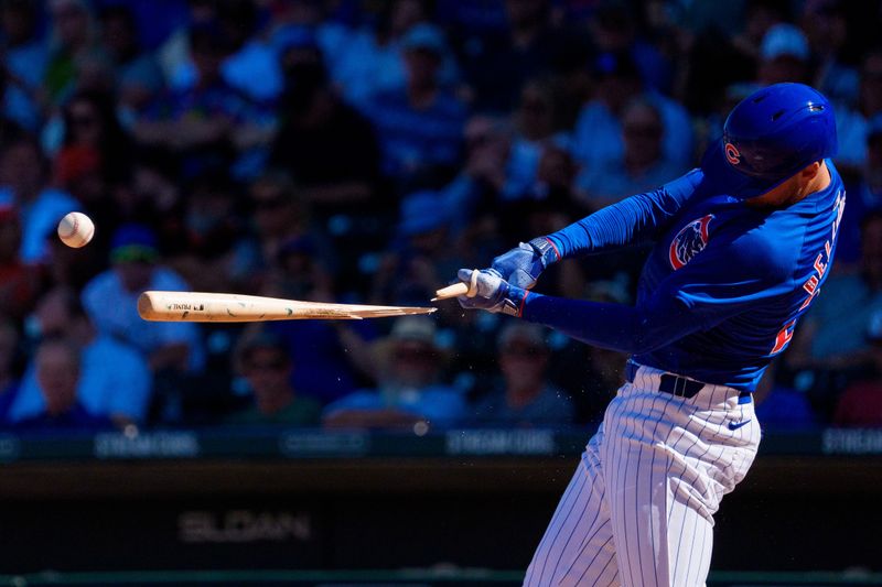 Mar 22, 2024; Mesa, Arizona, USA; Chicago Cubs outfielder Cody Bellinger (24) reacts as his bat breaks for a single in the sixth inning during a spring training game against the San Francisco Giants at Sloan Park. Mandatory Credit: Allan Henry-USA TODAY Sports