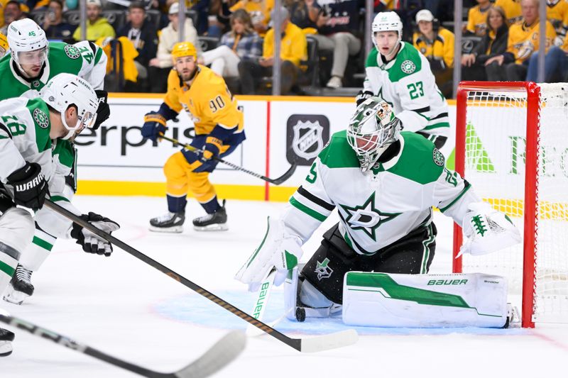 Oct 10, 2024; Nashville, Tennessee, USA; Dallas Stars goaltender Jake Oettinger (29) blocks the shot of Nashville Predators left wing Filip Forsberg (9) during the first period at Bridgestone Arena. Mandatory Credit: Steve Roberts-Imagn Images