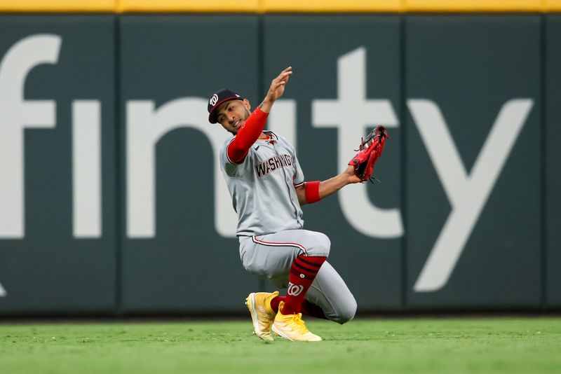 May 30, 2024; Atlanta, Georgia, USA; Washington Nationals left fielder Eddie Rosario (8) catches a fly ball against the Atlanta Braves in the seventh inning at Truist Park. Mandatory Credit: Brett Davis-USA TODAY Sports