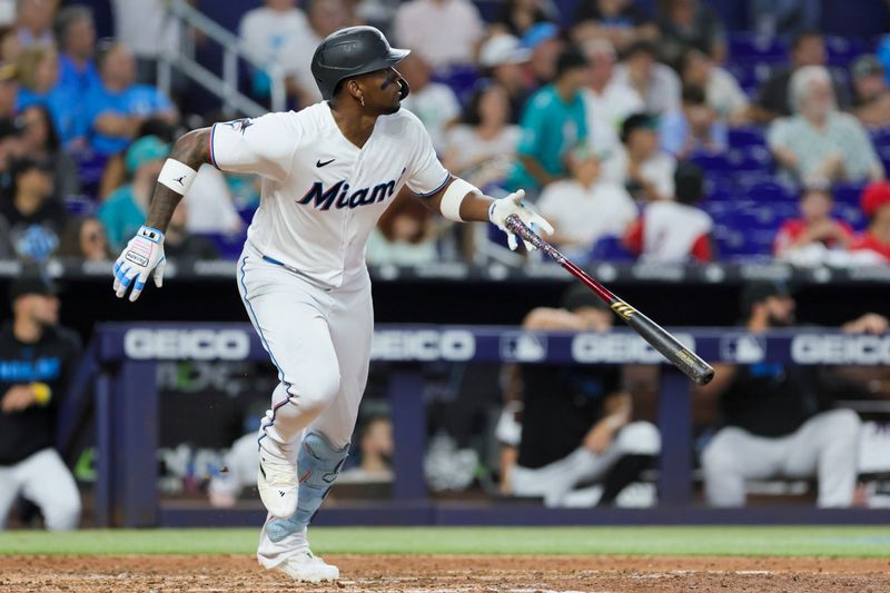 Sep 24, 2023; Miami, Florida, USA; Miami Marlins designated hitter Jorge Soler (12) watches after hitting a single against the Milwaukee Brewers during the sixth inning at loanDepot Park. Mandatory Credit: Sam Navarro-USA TODAY Sports