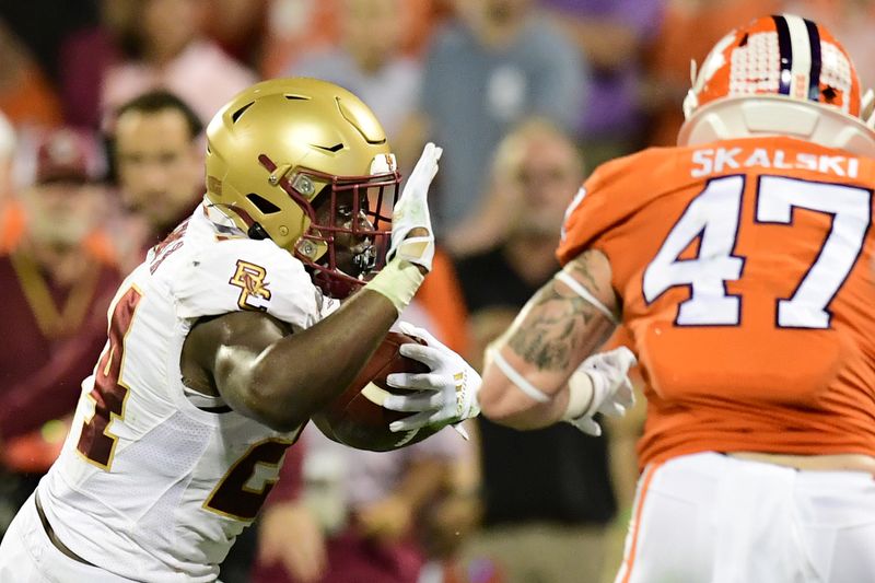 Oct 2, 2021; Clemson, South Carolina, USA; Boston College Eagles running back Pat Garwo III (24) carries the ball against Clemson Tigers linebacker James Skalski (47) during the first quarter at Memorial Stadium. Mandatory Credit: Adam Hagy-USA TODAY Sports