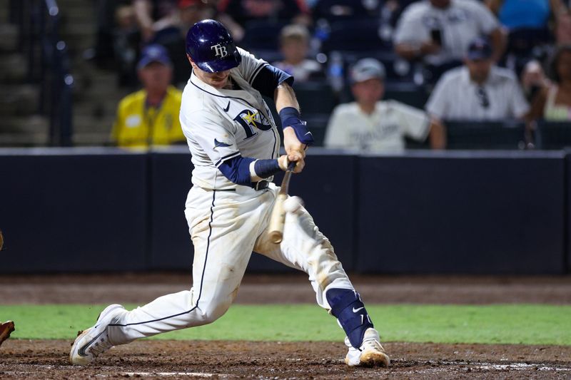 May 26, 2025; Tampa, Florida, USA; Tampa Bay Rays catcher Danny Jansen (19) hits a two run home run against the Minnesota Twins in the eighth inning at George M. Steinbrenner Field. Mandatory Credit: Nathan Ray Seebeck-Imagn Images