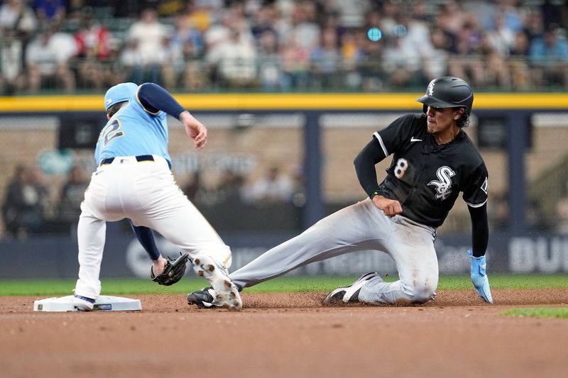 May 31, 2024; Milwaukee, Wisconsin, USA;  Chicago White Sox second baseman Nicky Lopez (8) is tagged by Milwaukee Brewers second baseman Brice Turang (2) while trying to steal second base during the first inning at American Family Field. Mandatory Credit: Jeff Hanisch-USA TODAY Sports