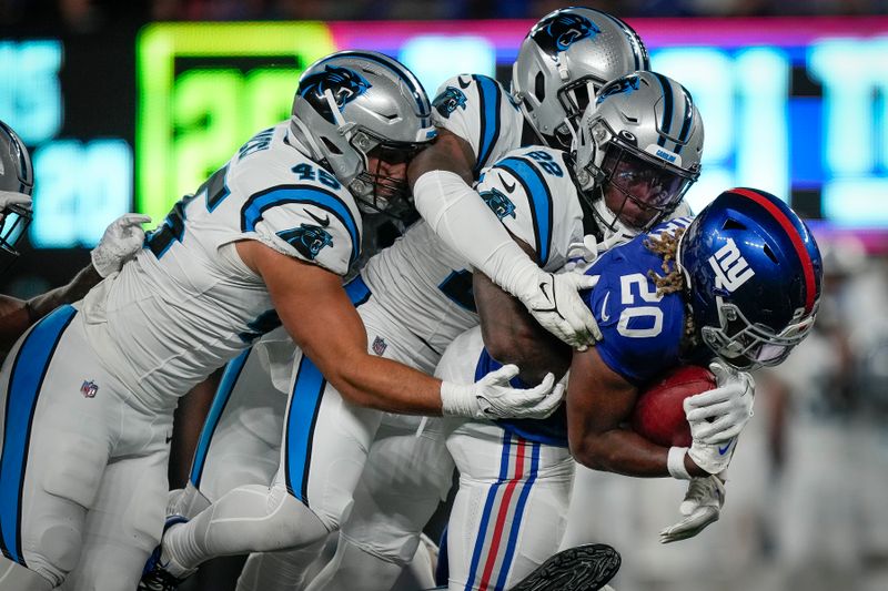 New York Giants running back Eric Gray is tackled by several Carolina Panthers defenders an NFL preseason football game against the Carolina Panthers, Friday, Aug. 18, 2023, in East Rutherford, N.J. (AP Photo/Bryan Woolston)