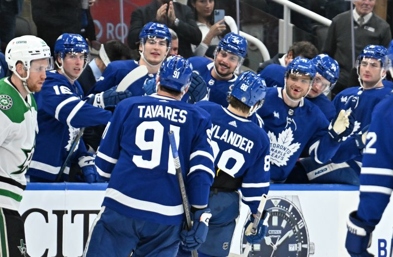 Feb 7, 2024; Toronto, Ontario, CAN; Toronto Maple Leafs forward William Nylander (88) is greeted by team mates at the bench after scoring against the Dallas Stars in the third period at Scotiabank Arena. Mandatory Credit: Dan Hamilton-USA TODAY Sports