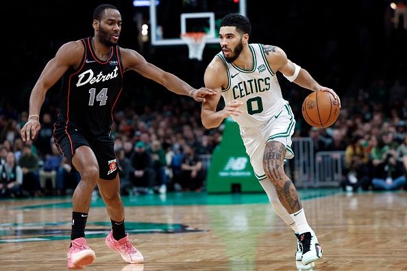 Boston, MA - December 28: Boston Celtics SF Jayson Tatum drives against Detroit Pistons SG Alec Burks. The Celtics beat the Pistons, 128-122, in overtime. (Photo by Danielle Parhizkaran/The Boston Globe via Getty Images)