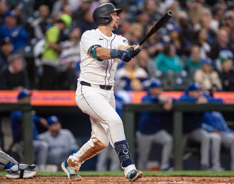 May 13, 2024; Seattle, Washington, USA; Seattle Mariners catcher Cal Raleigh (29) hits a RBI-single during the third inning against the Kansas City Royals at T-Mobile Park. Mandatory Credit: Stephen Brashear-USA TODAY Sports