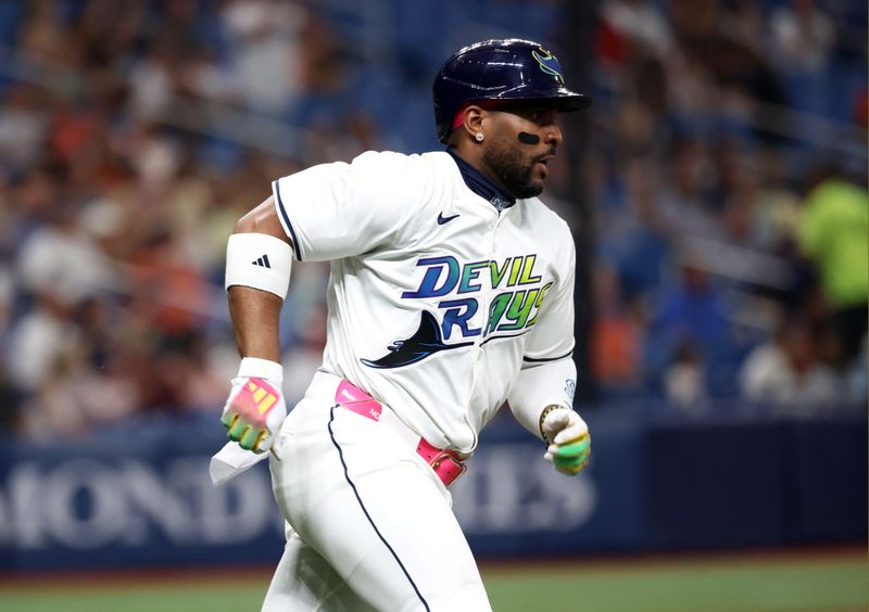 Jun 7, 2024; St. Petersburg, Florida, USA;Tampa Bay Rays first base Yandy Díaz (2) singles against the Baltimore Orioles during the third inning at Tropicana Field. Mandatory Credit: Kim Klement Neitzel-USA TODAY Sports