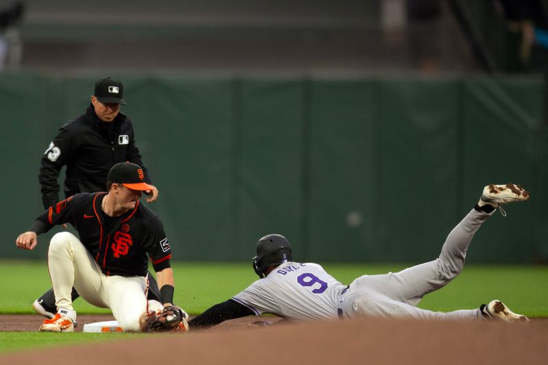 Jul 27, 2024; San Francisco, California, USA; San Francisco Giants shortstop Tyler Fitzgerald applies the tag too late to catch Colorado Rockies center fielder Brenton Doyle (9) as he steals second base during the first inning at Oracle Park. Umpire is Tripp Gibson. Mandatory Credit: D. Ross Cameron-USA TODAY Sports