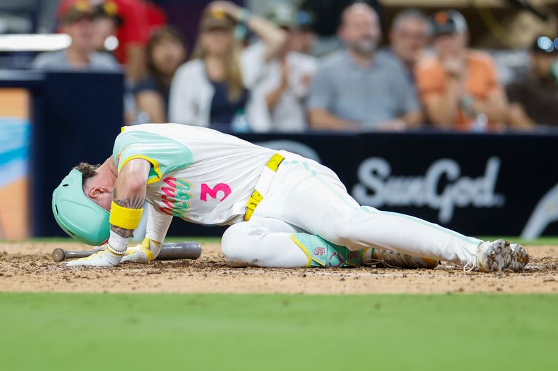 Sep 6, 2024; San Diego, California, USA; San Diego Padres center fielder Jackson Merrill (3) collapses after fouling a ball off his leg during the sixth inning against the San Francisco Giants at Petco Park. Mandatory Credit: David Frerker-Imagn Images