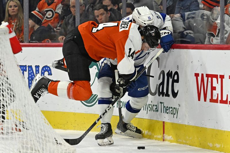 Jan 23, 2024; Philadelphia, Pennsylvania, USA; Philadelphia Flyers center Sean Couturier (14) and Tampa Bay Lightning center Luke Glendening (11) battle for the puck during the first period at Wells Fargo Center. Mandatory Credit: Eric Hartline-USA TODAY Sports