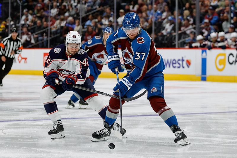 Mar 22, 2024; Denver, Colorado, USA; Colorado Avalanche center Casey Mittelstadt (37) controls the puck under pressure from Columbus Blue Jackets center Alexandre Texier (42) in the second period at Ball Arena. Mandatory Credit: Isaiah J. Downing-USA TODAY Sports