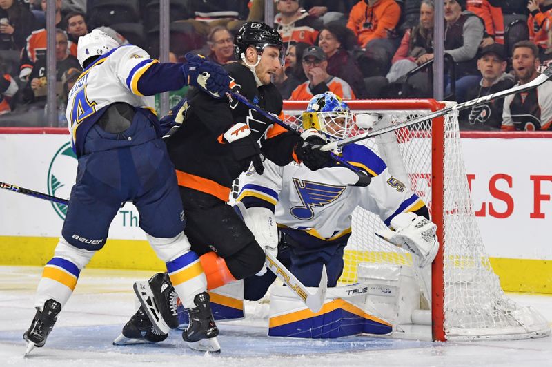 Mar 4, 2024; Philadelphia, Pennsylvania, USA; Philadelphia Flyers right wing Garnet Hathaway (19) and St. Louis Blues goaltender Jordan Binnington (50) follow the puck during the second period at Wells Fargo Center. Mandatory Credit: Eric Hartline-USA TODAY Sports