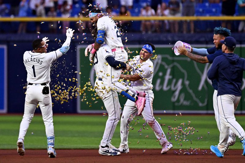 May 29, 2024; St. Petersburg, Florida, USA; Tampa Bay Rays center fielder Jose Siri (22) celebrates with his teammates after defeating the Oakland Athletics  at Tropicana Field. Mandatory Credit: Jonathan Dyer-USA TODAY Sports