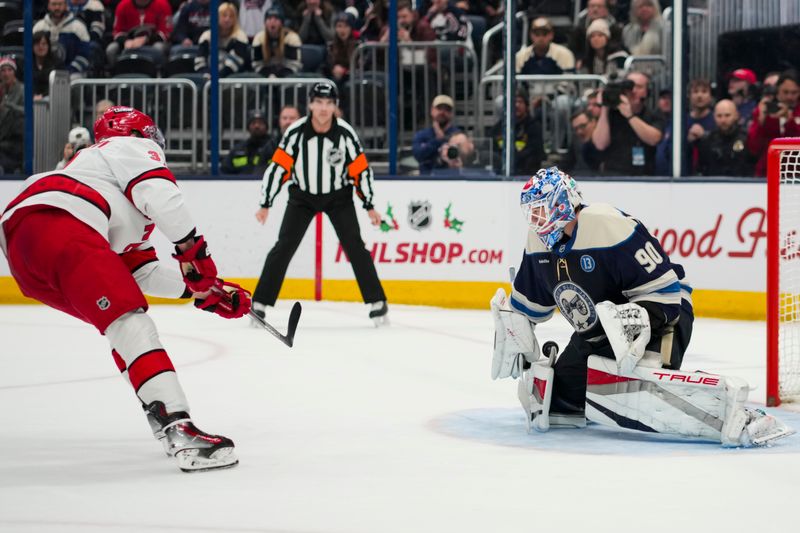 Nov 23, 2024; Columbus, Ohio, USA;  Columbus Blue Jackets goaltender Elvis Merzlikins (90) makes a save in net against Carolina Hurricanes right wing Andrei Svechnikov (37) in the shootout at Nationwide Arena. Mandatory Credit: Aaron Doster-Imagn Images