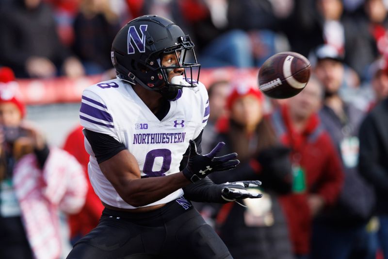 Nov 11, 2023; Madison, Wisconsin, USA;  Northwestern Wildcats wide receiver A.J. Henning (8) catches a pass to score a touchdown during the first quarter against the Wisconsin Badgers at Camp Randall Stadium. Mandatory Credit: Jeff Hanisch-USA TODAY Sports