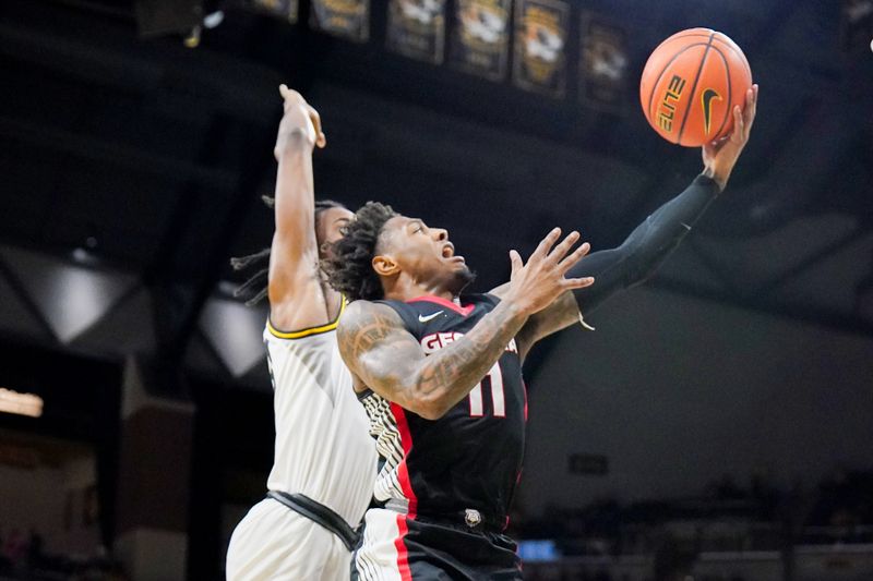 Jan 6, 2024; Columbia, Missouri, USA; Georgia Bulldogs guard Justin Hill (11) shoots as Missouri Tigers forward Aidan Shaw (23) defends during the second half at Mizzou Arena. Mandatory Credit: Denny Medley-USA TODAY Sports