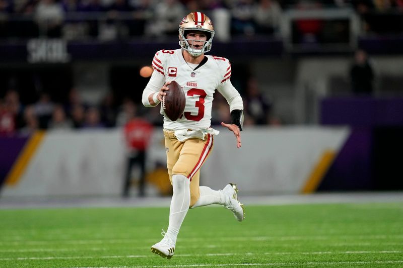 San Francisco 49ers quarterback Brock Purdy (13) scrambles up field during the first half of an NFL football game against the Minnesota Vikings, Monday, Oct. 23, 2023, in Minneapolis. (AP Photo/Abbie Parr)