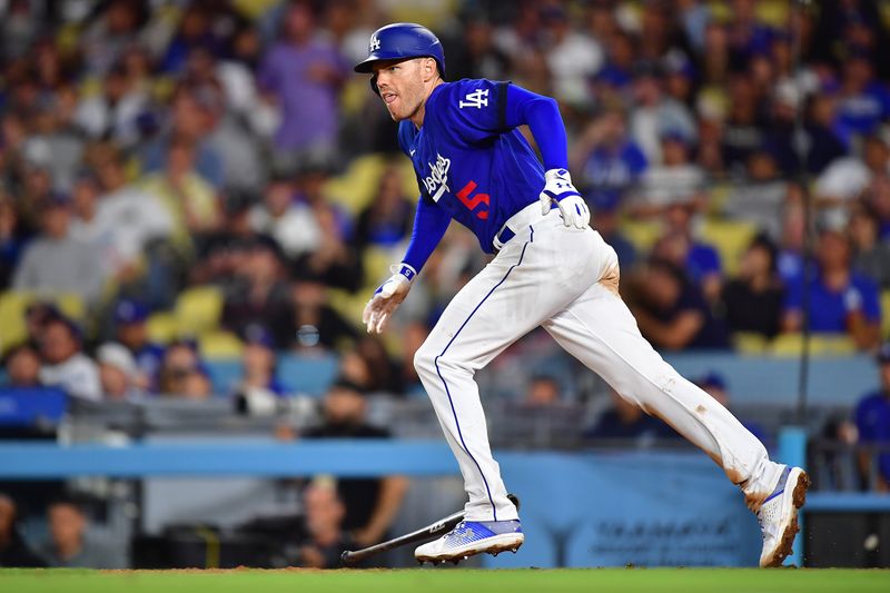 Jul 6, 2023; Los Angeles, California, USA; Los Angeles Dodgers first baseman Freddie Freeman (5) hits a n RBI single against the Pittsburgh Pirates during the seventh inning at Dodger Stadium. Mandatory Credit: Gary A. Vasquez-USA TODAY Sports