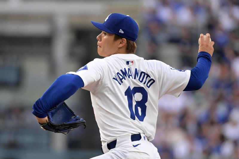 Oct 11, 2024; Los Angeles, California, USA; Los Angeles Dodgers pitcher Yoshinobu Yamamoto (18) pitches against the San Diego Padres in the second inning during game five of the NLDS for the 2024 MLB Playoffs at Dodger Stadium. Mandatory Credit: Jayne Kamin-Oncea-Imagn Images