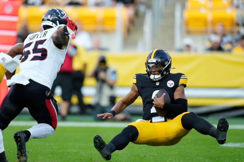 Pittsburgh Steelers quarterback Justin Fields, right, is sacked by Houston Texans defensive end Danielle Hunter, left, in the first half of a preseason NFL football game, Friday, Aug. 9, 2024, in Pittsburgh. (AP Photo/Gene J. Puskar)