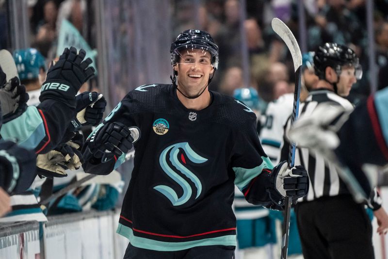 Apr 11, 2024; Seattle, Washington, USA; Seattle Kraken defenseman Brian Dumoulin (8) celebrates with teammates on the bench after scoring a goal against the San Jose Sharks during the first period at Climate Pledge Arena. Mandatory Credit: Stephen Brashear-USA TODAY Sports