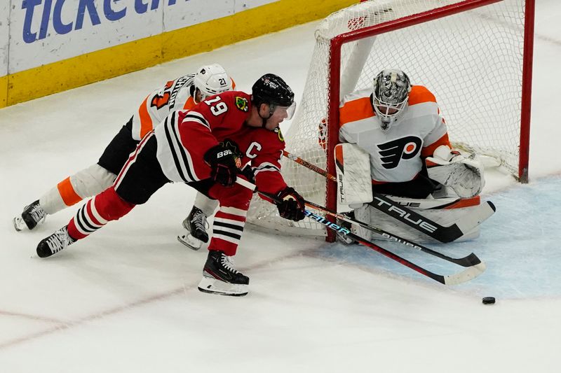 Apr 13, 2023; Chicago, Illinois, USA; Philadelphia Flyers goaltender Felix Sandstrom (32) makes a save on Chicago Blackhawks center Jonathan Toews (19) during the first period at United Center. Mandatory Credit: David Banks-USA TODAY Sports