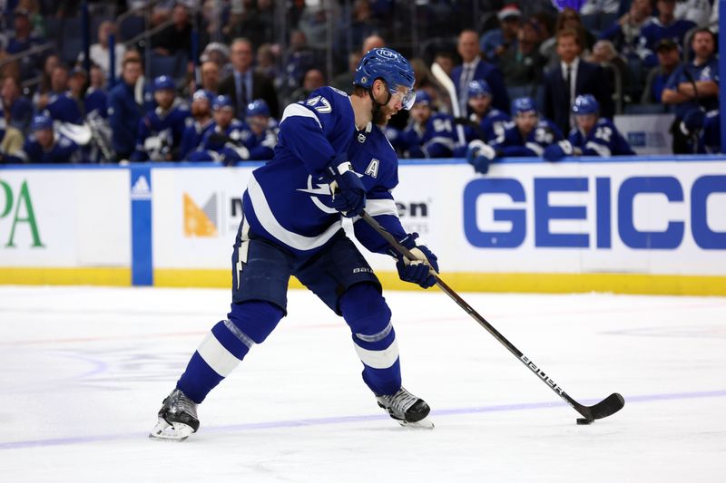 Dec 4, 2023; Tampa, Florida, USA; Tampa Bay Lightning defenseman Victor Hedman (77) skates with the puck against the Dallas Stars during the third period at Amalie Arena. Mandatory Credit: Kim Klement Neitzel-USA TODAY Sports