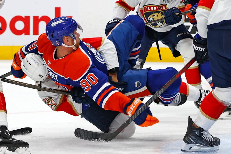 Jun 6, 2025; Edmonton, Alberta, CAN; Florida Panthers defenseman Seth Jones (3) checks Edmonton Oilers right wing Corey Perry (90) during the first period in game two of the 2025 Stanley Cup Final at Rogers Place. Mandatory Credit: Perry Nelson-Imagn Images