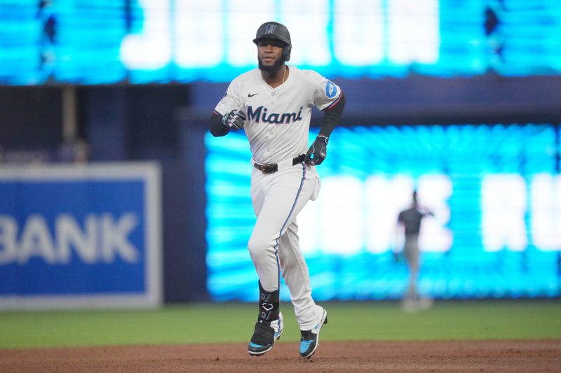 Jun 4, 2024; Miami, Florida, USA; Miami Marlins designated hitter Bryan De La Cruz (14) rounds the bases after hitting a home run against the Tampa Bay Rays in the first inning at loanDepot Park. Mandatory Credit: Jim Rassol-USA TODAY Sports