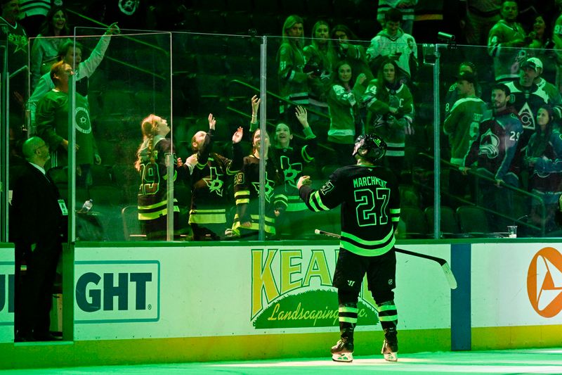 Nov 29, 2024; Dallas, Texas, USA; Dallas Stars left wing Mason Marchment (27) tosses a puck to the fans after the game against the Colorado Avalanche at the American Airlines Center. Mandatory Credit: Jerome Miron-Imagn Images