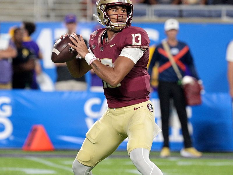 Sep 3, 2023; Orlando, Florida, USA; Florida State Seminoles quarterback Jordan Travis (13) throws the ball during the first half against the Louisiana State Tigers at Camping World Stadium. Mandatory Credit: Melina Myers-USA TODAY Sports