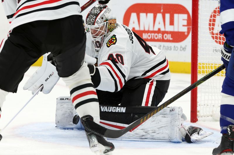 Jan 28, 2025; Tampa, Florida, USA; Chicago Blackhawks goaltender Arvid Soderblom (40) makes a save against the Tampa Bay Lightning during the first period at Amalie Arena. Mandatory Credit: Kim Klement Neitzel-Imagn Images