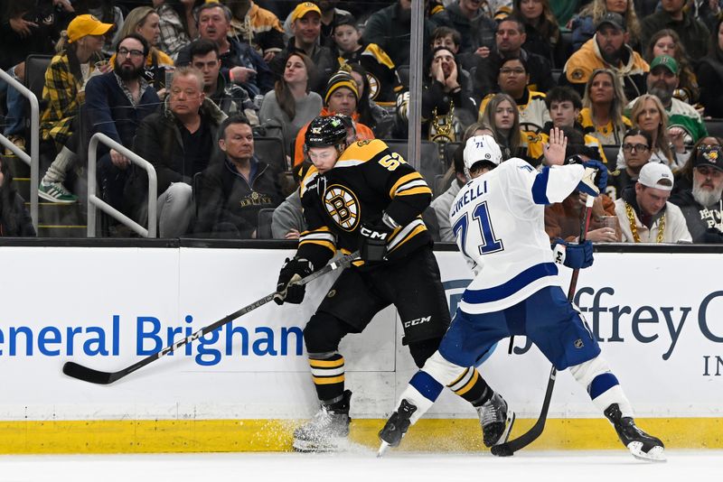 Mar 15, 2025; Boston, Massachusetts, USA; Tampa Bay Lightning center Anthony Cirelli (71) hits Boston Bruins defenseman Andrew Peeke (52) while controlling the puck during the third period at TD Garden. Mandatory Credit: Eric Canha-Imagn Images
