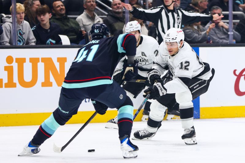 Dec 10, 2025; Seattle, Washington, USA; Seattle Kraken defenseman Ryker Evans (41) blocks a pass by Los Angeles Kings left wing Trevor Moore (12) in the second period at Climate Pledge Arena. Mandatory Credit: Kevin Ng-Imagn Images