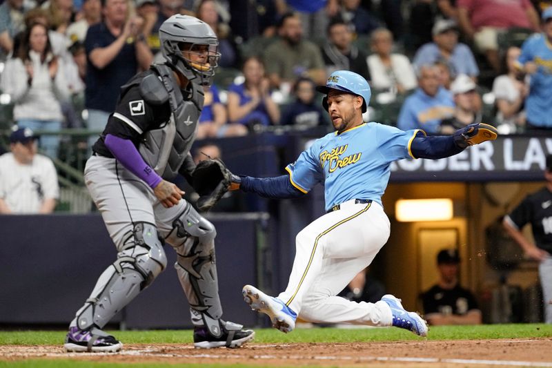 May 31, 2024; Milwaukee, Wisconsin, USA;  Milwaukee Brewers center fielder Blake Perkins (16) slides into home plate to score a run during the fourth inning against the Chicago White Sox at American Family Field. Mandatory Credit: Jeff Hanisch-USA TODAY Sports