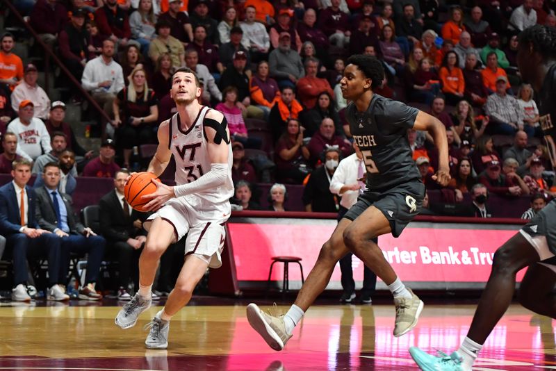 Jan 27, 2024; Blacksburg, Virginia, USA; Virginia Tech Hokies forward Robbie Beran (31) drives to the basket while being defended by Georgia Tech Yellow Jackets forward Tafara Gapare (5) during the second half at Cassell Coliseum. Mandatory Credit: Brian Bishop-USA TODAY Sports